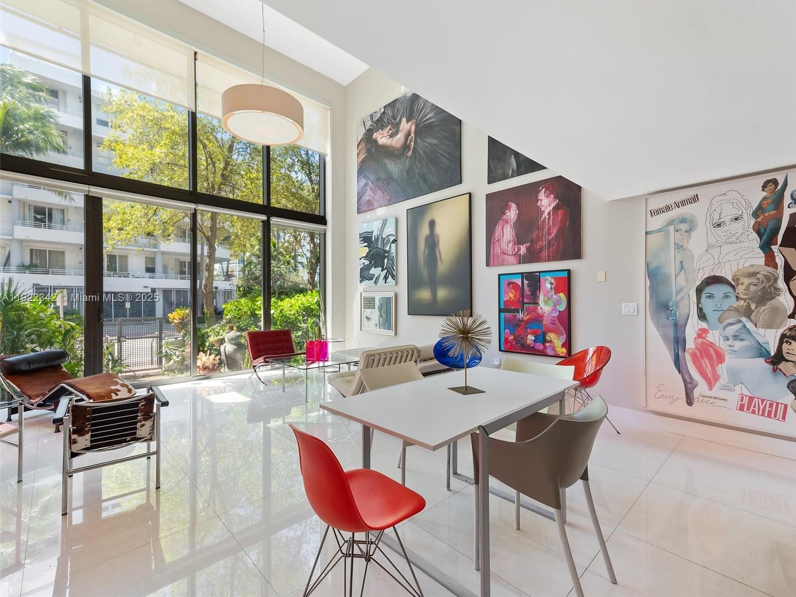 6000 Collins Avenue, Unit 132 Miami Beach, FL 33140 - Photo 2 of 14 a view of a dining room with furniture one side kitchen view and wooden floor
