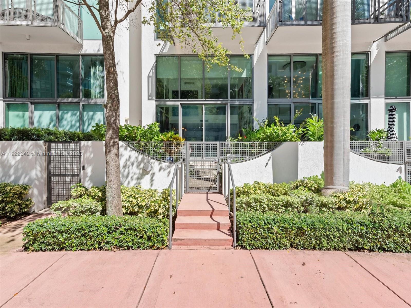 6000 Collins Avenue, Unit 132 Miami Beach, FL 33140 - Photo 4 of 14 front view of a house with a yard