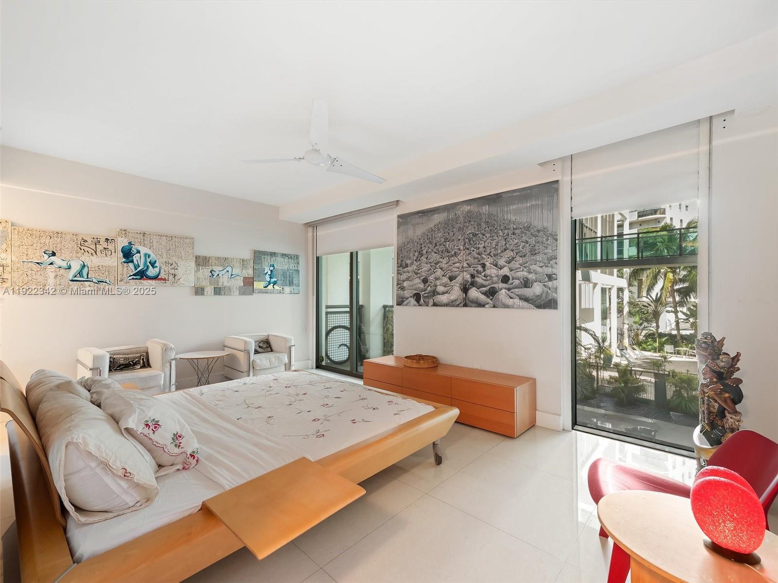 6000 Collins Avenue, Unit 132 Miami Beach, FL 33140 - Photo 6 of 14 a bedroom with a large bed and a couch