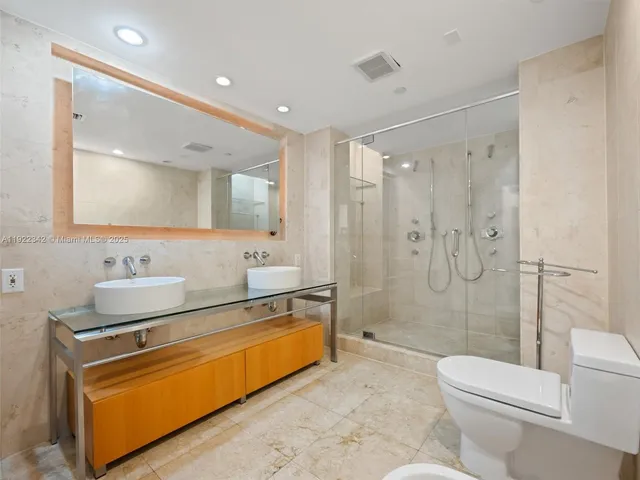 a spacious bathroom with a sink mirror toilet and shower