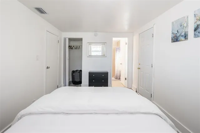 a large bed in a bedroom with closet