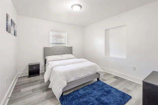 a bedroom with a bed and a rug