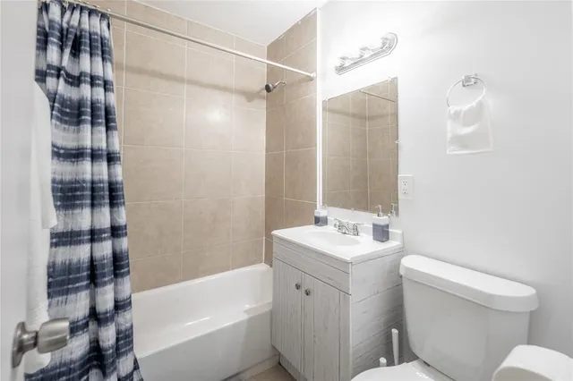 a bathroom with a sink toilet vanity and shower