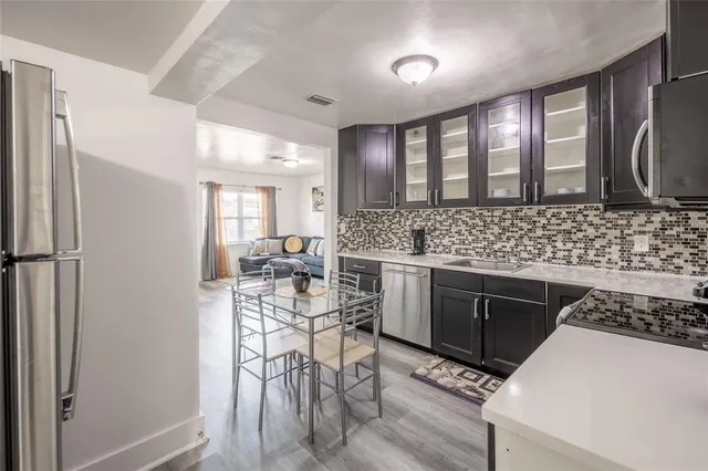 a kitchen with sink cabinets and stainless steel appliances