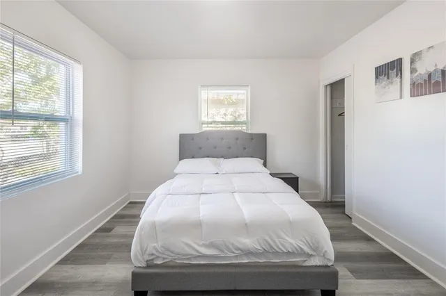 a room with a bed and wooden floor