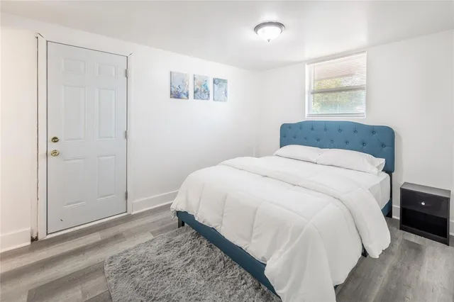 a spacious bedroom with a bed and a window