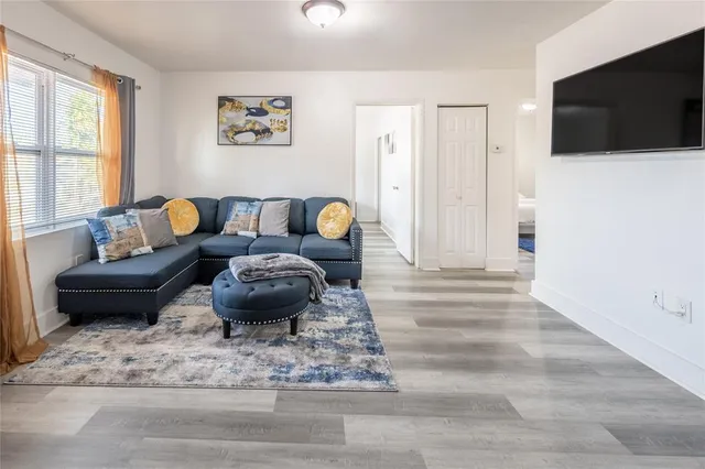 a living room with furniture and a flat screen tv