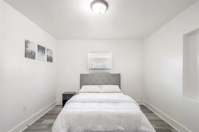 a bedroom with a bed and lamp