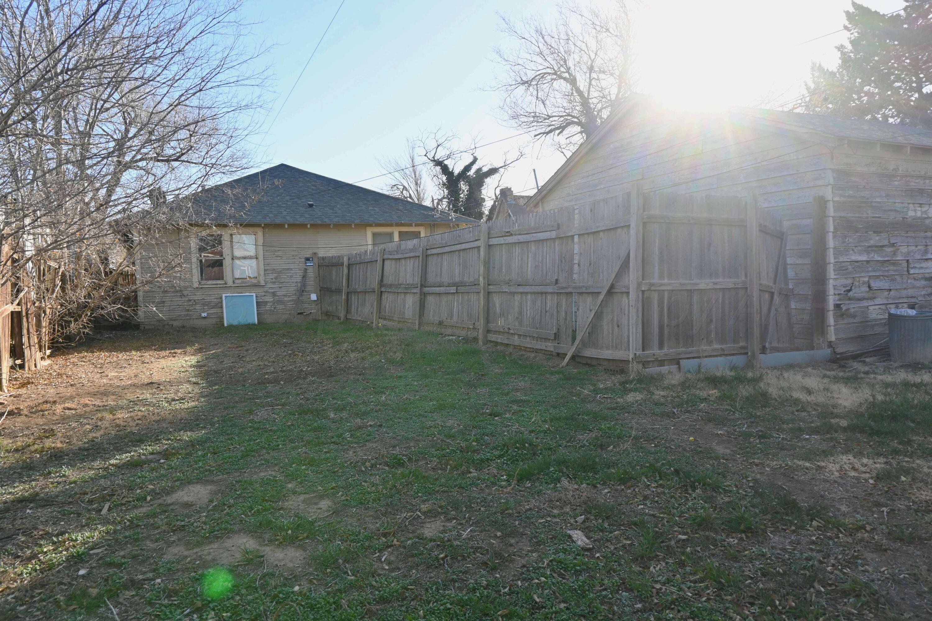 3702 South Polk Street Amarillo, TX 79110 - Photo 2 of 19 a view of a yard in front of a house with large trees