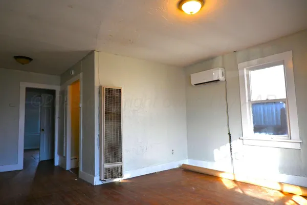 a view of a livingroom with wooden floor and window