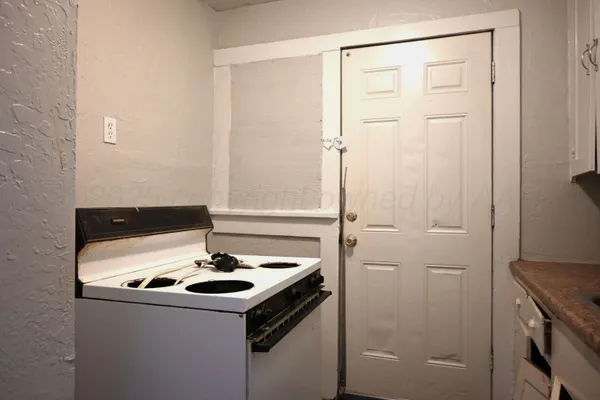 a kitchen with a sink and a refrigerator