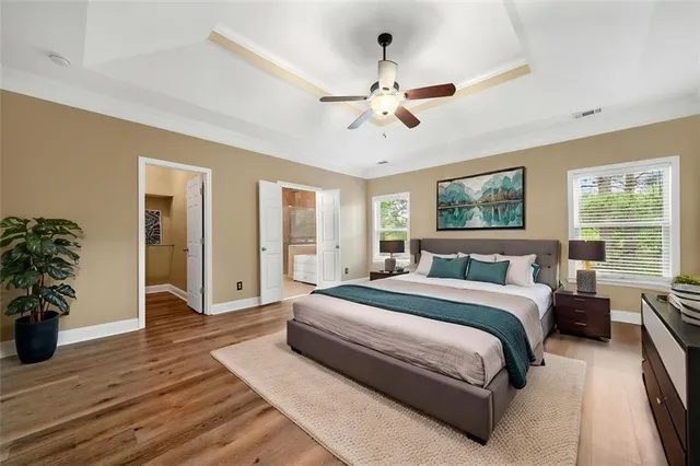 a spacious bedroom with a large bed and a chandelier