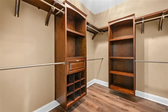 a view of walk in closet with empty racks