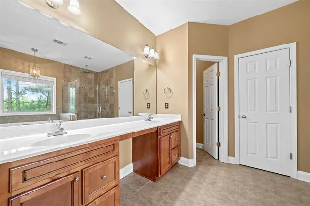 a bathroom with a sink double vanity and a large mirror