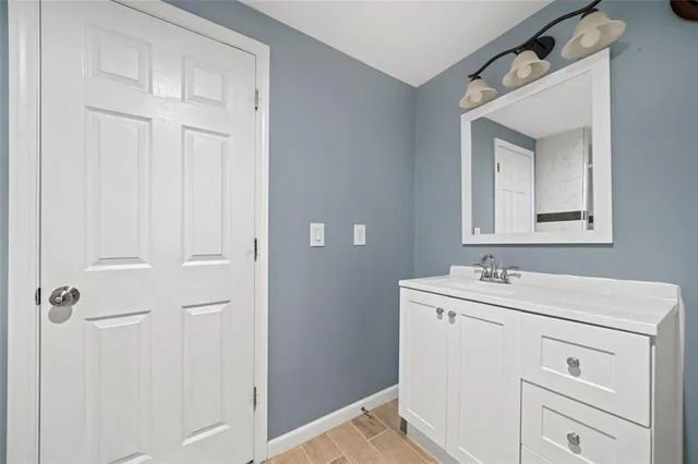 a bathroom with a sink vanity and a mirror