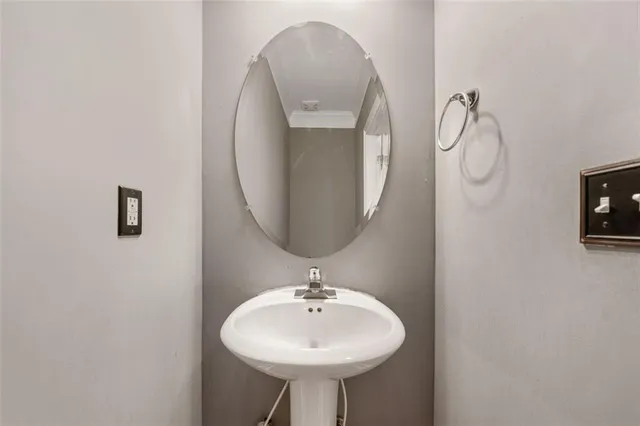 a bathroom with a sink a mirror and a lamp