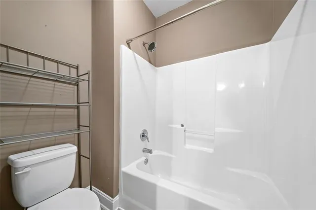 a bathroom with a toilet and a bathtub