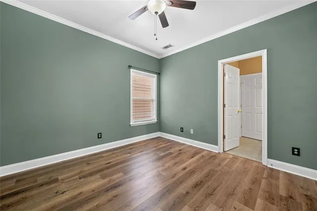 a view of room with window and ceiling fan