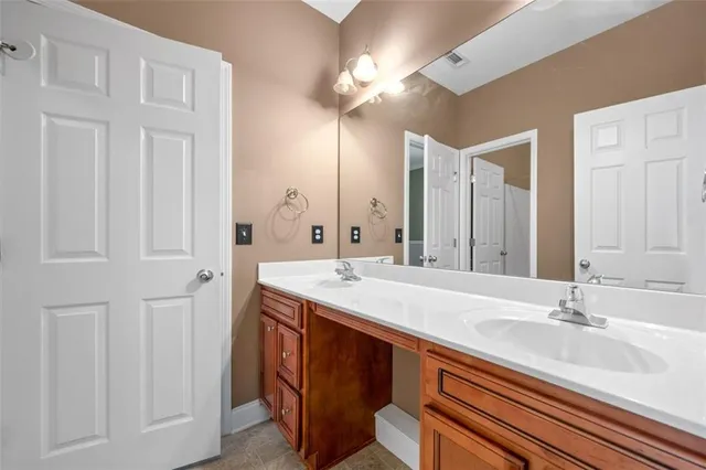 a bathroom with a sink double vanity and a mirror