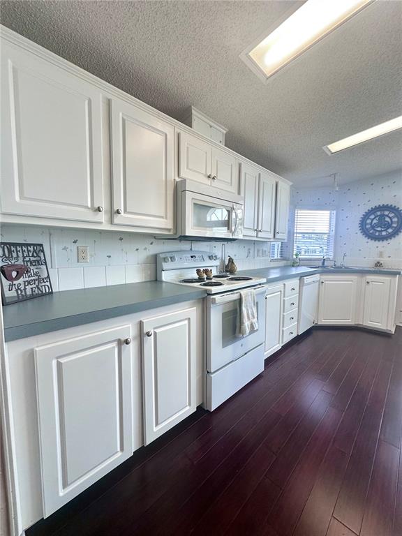 1100 South Belcher Road, Unit 406 Largo, FL 33771 - Photo 7 of 46 a kitchen with granite countertop white cabinets and white appliances