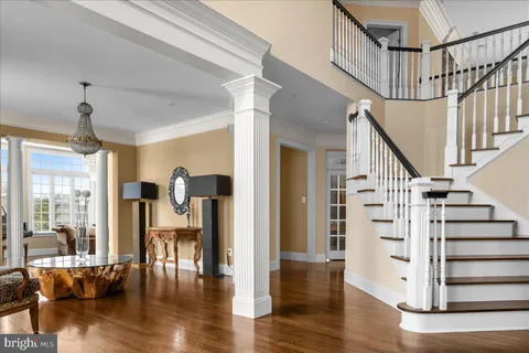 a view of entryway and hall with wooden floor