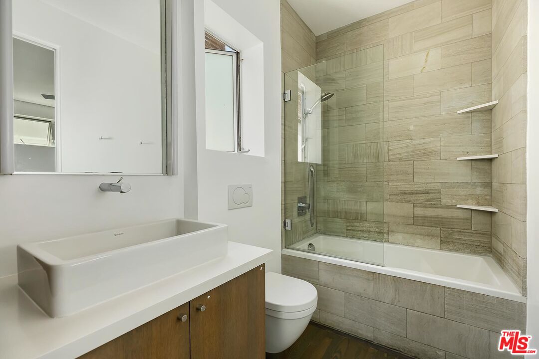 705 Sunset Avenue, Unit 1/2 Venice, CA 90291 - Photo 11 of 16 a bathroom with a sink a toilet and bathtub