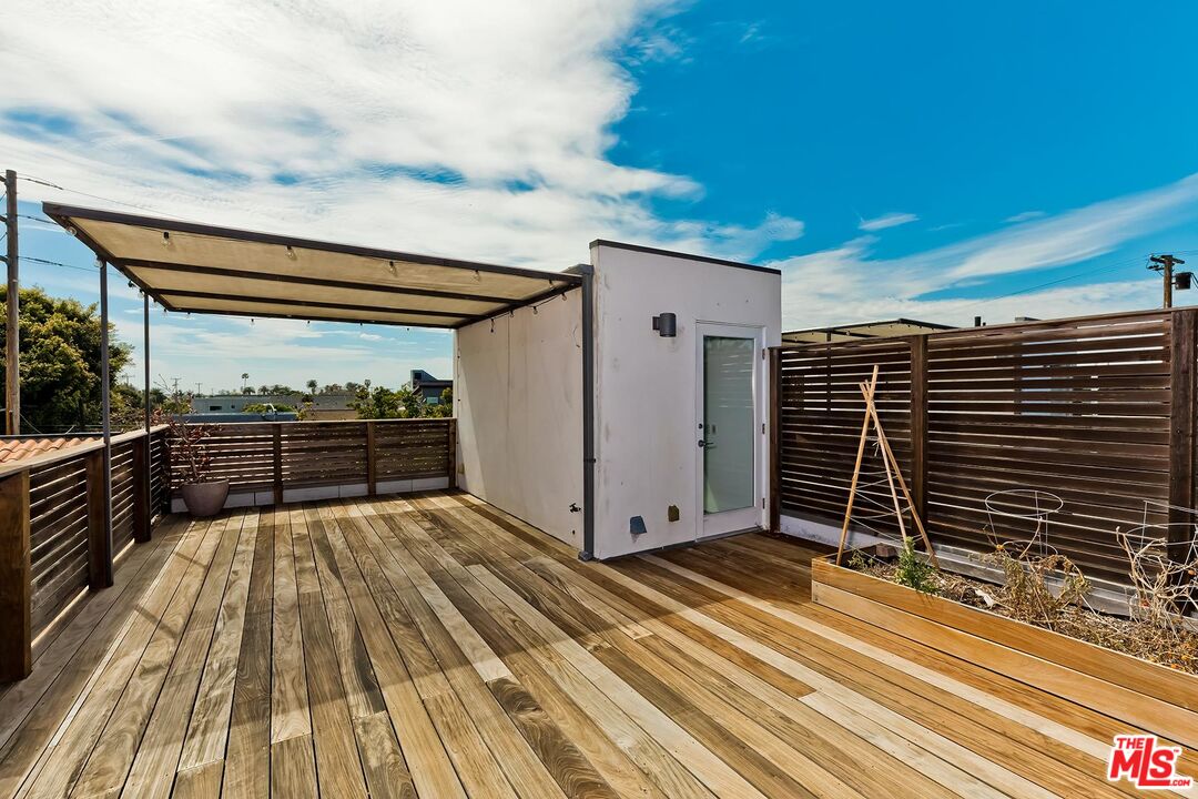 705 Sunset Avenue, Unit 1/2 Venice, CA 90291 - Photo 13 of 16 a view of a balcony with wooden floor and fence