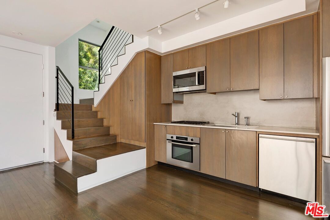 705 Sunset Avenue, Unit 1/2 Venice, CA 90291 - Photo 4 of 16 a kitchen with stainless steel appliances granite countertop a stove a sink and a microwave