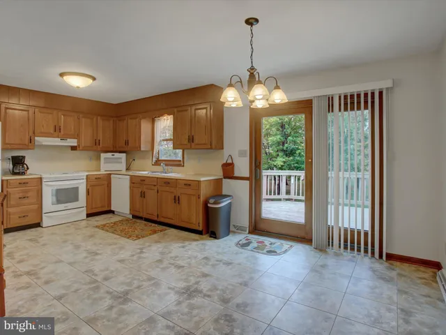 a kitchen that has a lot of cabinets and wooden floor