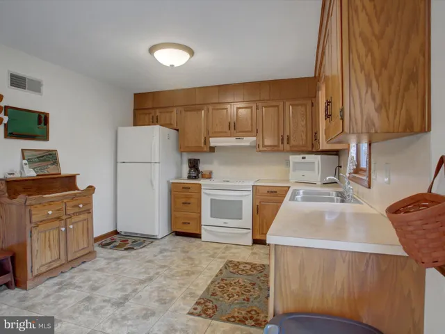 a kitchen with a refrigerator sink and stove