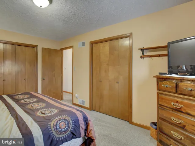 a bedroom with a bed and a television