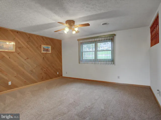 a large bed sitting in a room next to a lamp
