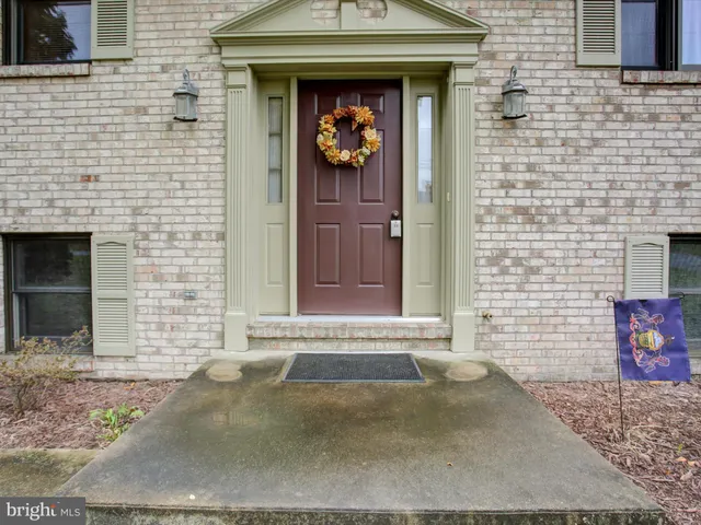 a view of a brick house with potted plants