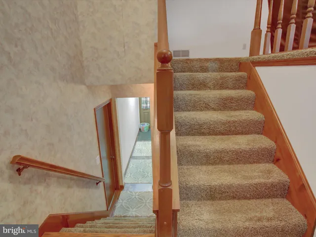 a view of staircase with rug