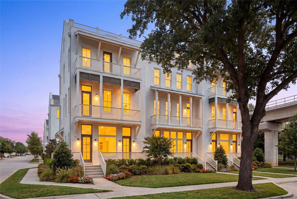a front view of a residential apartment building with a yard