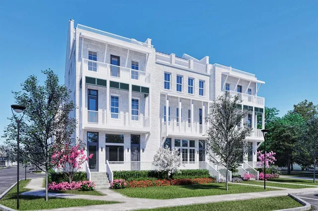 a front view of a building with a garden and plants