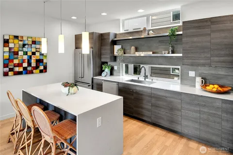 a kitchen with stainless steel appliances kitchen island granite countertop a stove a sink and a microwave