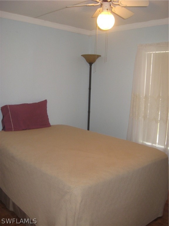 1260 Old Bridge Road North Fort Myers, FL 33917 - Photo 12 of 29 a bedroom with a bed and a chandelier