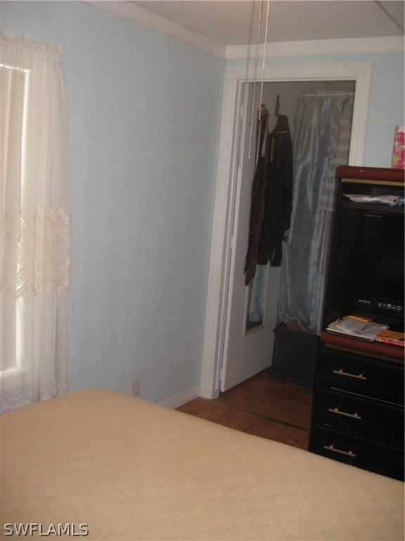 1260 Old Bridge Road North Fort Myers, FL 33917 - Photo 13 of 29 a bedroom with a bed and a flat tv screen on a dresser