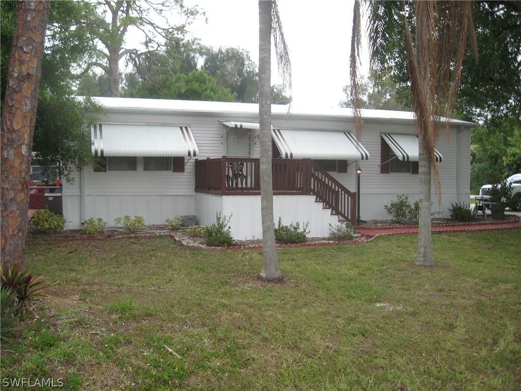 1260 Old Bridge Road North Fort Myers, FL 33917 - Photo 2 of 29 a view of a house with a yard