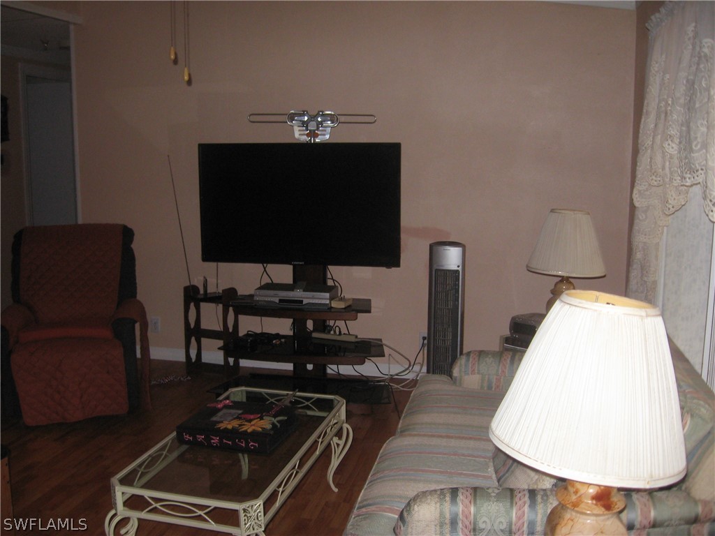 1260 Old Bridge Road North Fort Myers, FL 33917 - Photo 3 of 29 a living room with furniture and a flat screen tv