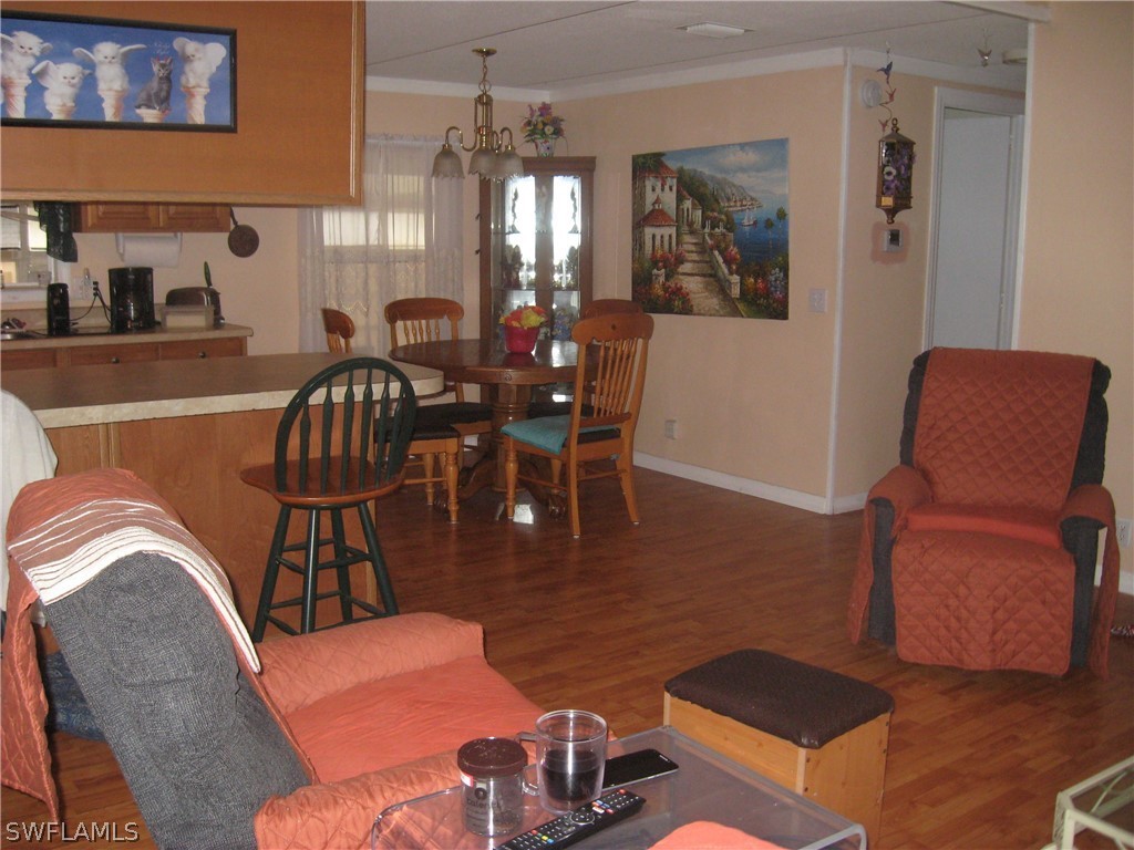 1260 Old Bridge Road North Fort Myers, FL 33917 - Photo 4 of 29 a living room with furniture and a chandelier