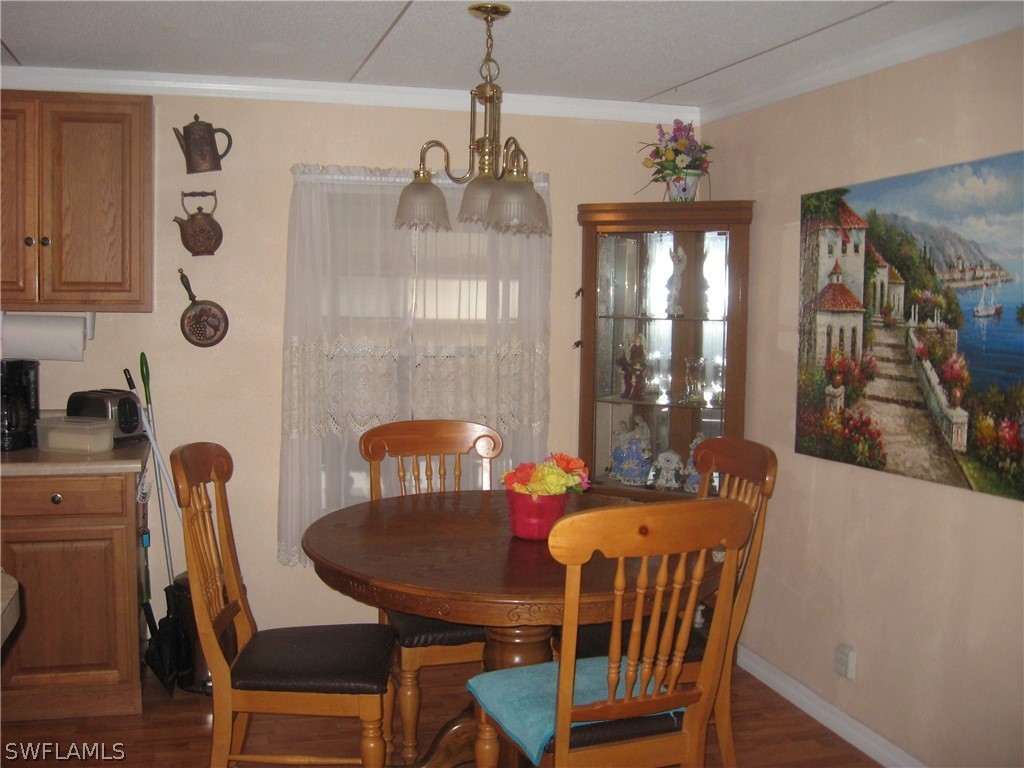 1260 Old Bridge Road North Fort Myers, FL 33917 - Photo 5 of 29 a view of a dining room with furniture and chandelier