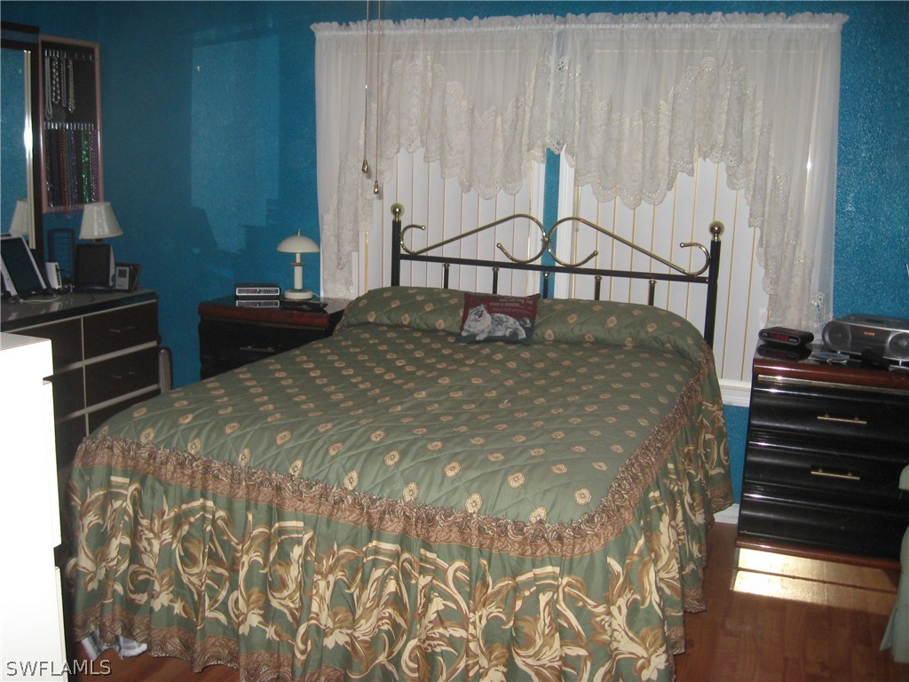 1260 Old Bridge Road North Fort Myers, FL 33917 - Photo 10 of 29 a bedroom with a bed and a flat tv screen on the dresser