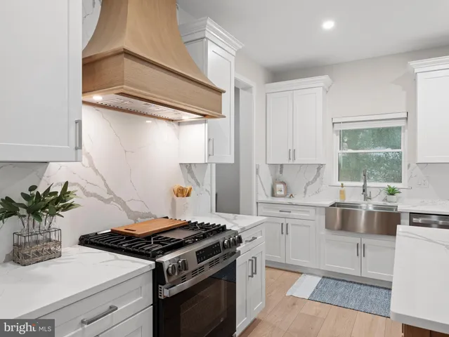 a large kitchen with a table and chairs