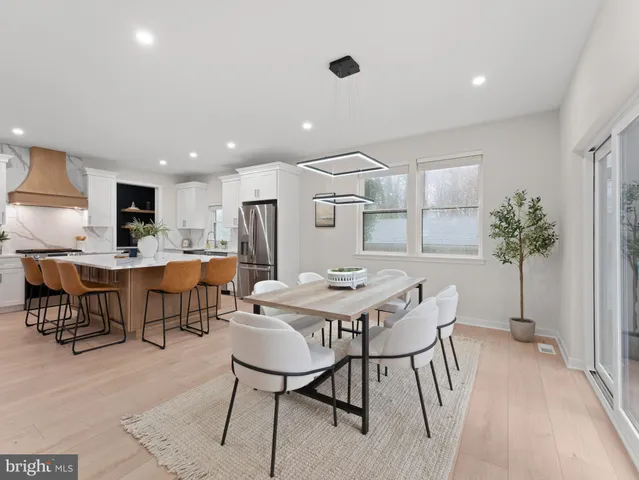 a large kitchen with a table and chairs