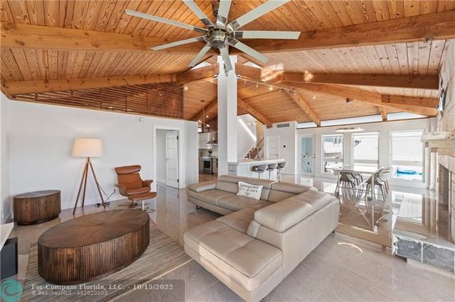 a bedroom with a bed and a large window with outer view