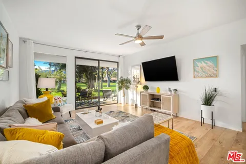 a living room with furniture and kitchen view