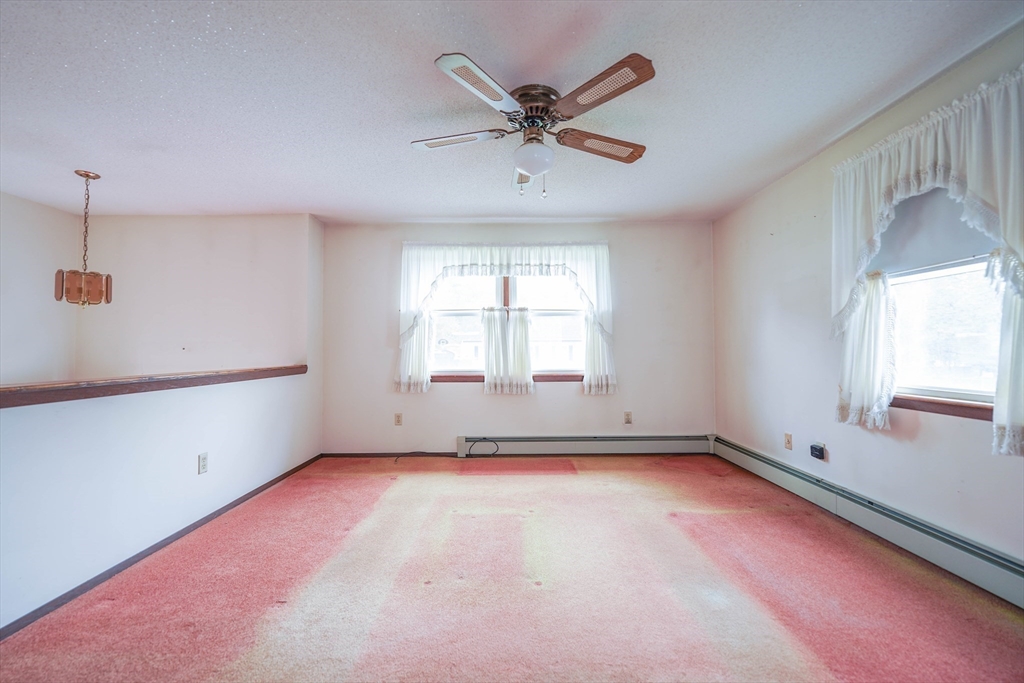 1069 Cherokee Street New Bedford, MA 02745 - Photo 16 of 21 an empty room with windows and fan