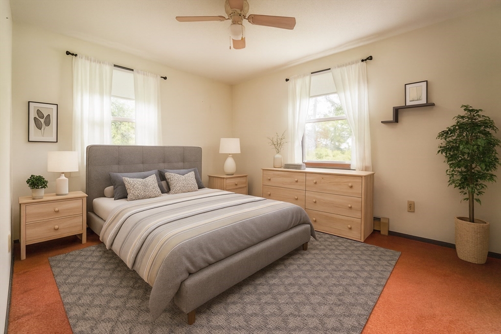 1069 Cherokee Street New Bedford, MA 02745 - Photo 6 of 21 a bedroom with a bed and a potted plant